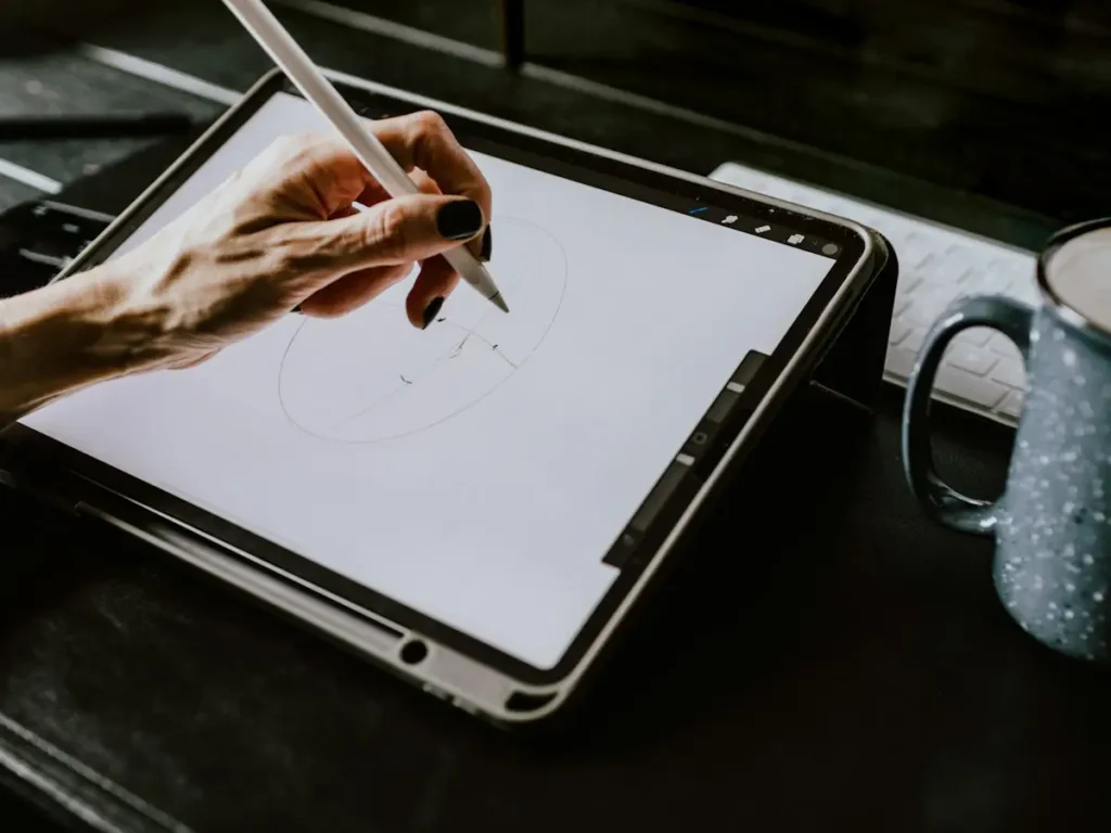 Illustrator drawing a custom digital illustration on an iPad