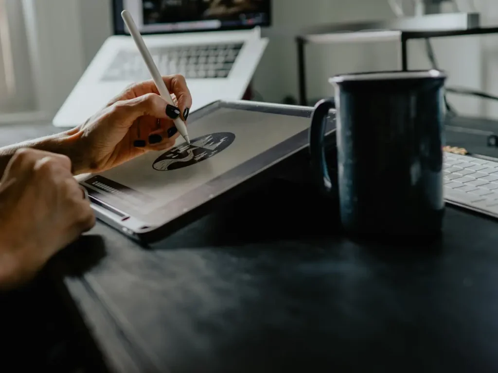 Designer sketching a logo concept on a tablet with a stylus