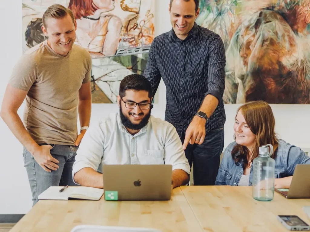 Design team reviewing a brand project together on a laptop